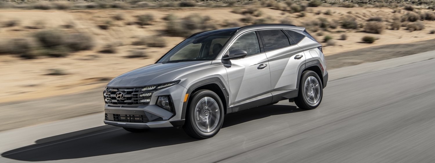 Silver Hyundai Tucson compact SUV driving on a desert highway